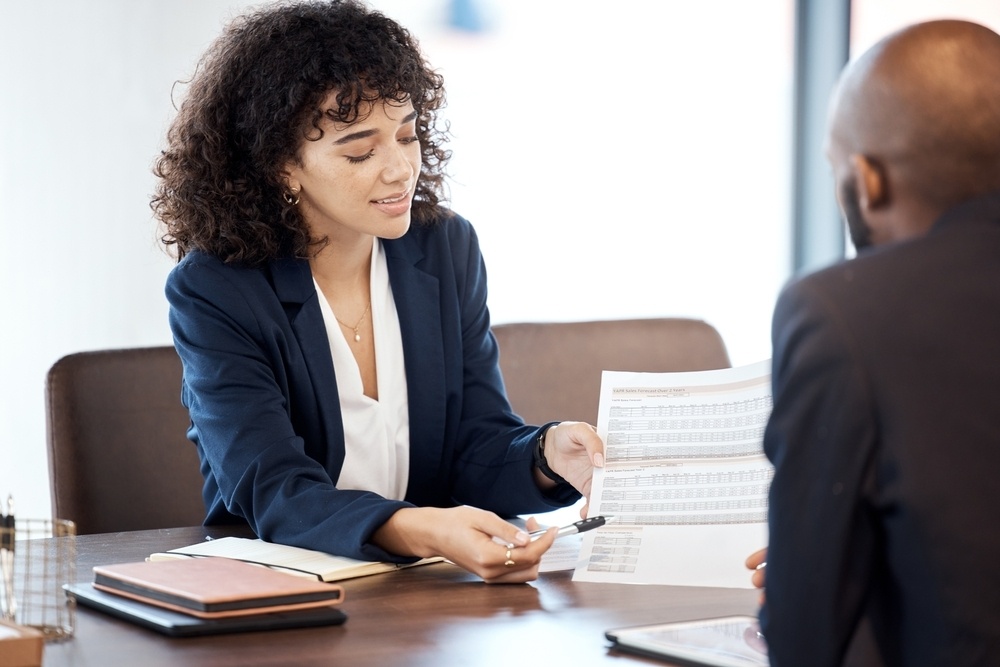 Attorney-consults-with-trustee-on-paperwork-in-office-shutterstock_2261946135